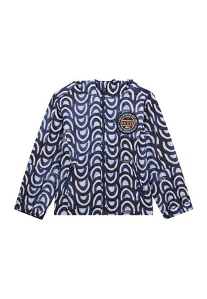 Giacca zip-up blu navy con cappuccio, caratterizzata da un motivo bianco curvo ripetitivo e un logo circolare sul petto. Texture liscia.