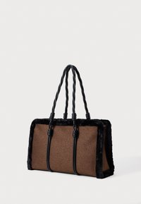 Brown woven fabric handbag with black faux fur trim and twisted black handles. Rectangular shape, structured design, and visible stitching details.