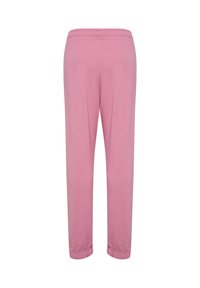 Hellrosa Sweatpants mit elastischem Bund und zulaufenden Beinabschlüssen. Hergestellt aus weichem Stoff mit glatter Textur, entwickelt für Komfort.