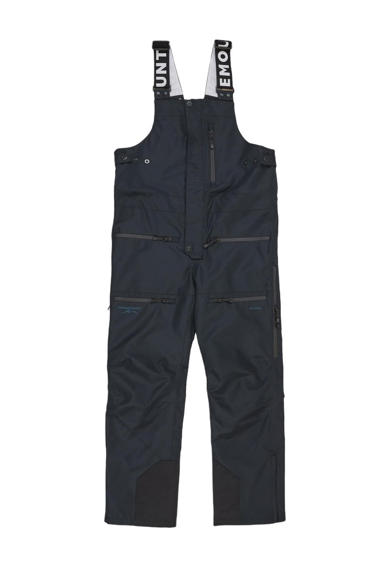 Salopette blu navy con spallacci regolabili, numerose tasche con zip, rinforzi neri sulle ginocchia e una texture del tessuto impermeabile.