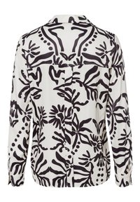 Long-sleeve blouse in lightweight fabric, featuring a black floral pattern on a white background, with a buttoned back and collar.