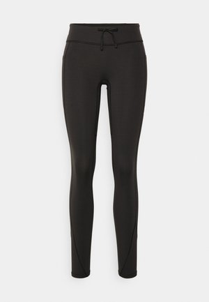 Zwarte leggings met een hoge tailleband, een trekkoord, een gladde textuur en een aansluitend ontwerp. Kenmerkt zich door stikseldetails langs de zijkanten.