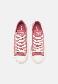 Roze canvas low-top sneakers met een witte rubberen teenkap en veters, met een gewatteerde tong en een gelabelde binnenzool. Klassiek ontwerp.