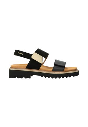 Sandale en cuir noir avec semelle intérieure beige, semelle épaisse texturée, deux brides réglables et accent métallique sur la bride de la cheville.