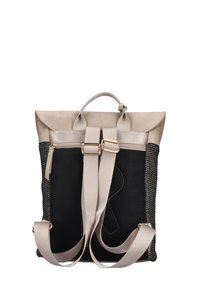 Sac à dos avec un rabat en suède beige, un corps en tissu mesh noir et texturé, des sangles beige réglables et une poche latérale zippée.