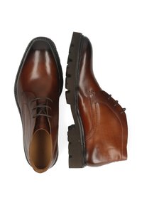 Zapatos de cuero marrón con un acabado liso, puntera redondeada, diseño con cordones y suela resistente con relieves prominentes.