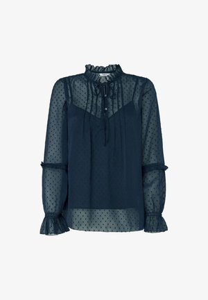 Blusa sheer azul marino con patrón de lunares. Presenta un cuello con volantes, cierre de botones y mangas acampanadas con acentos de volantes.