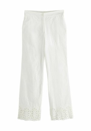 White straight-leg pants with intricate lace trim at the hem and a subtle floral pattern throughout the fabric.