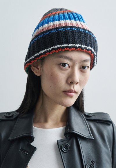 Knit beanie with horizontal stripes in blue, pink, and black; features a textured finish and a contrasting orange accent at the bottom.