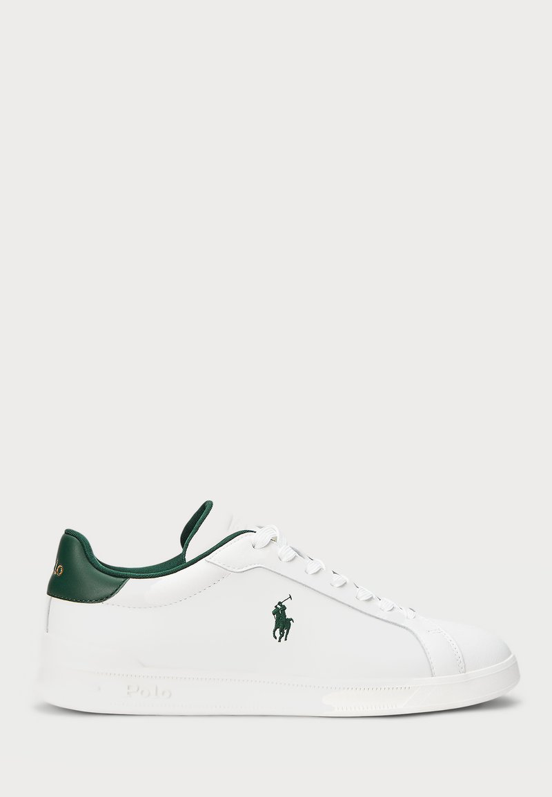 Valged sneakers roheliste aktsentidega, sileda nahast materjal, ümar varvas, nöörkinnis ja logo küljel ja kandadel.