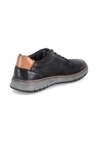 Scarpa di pelle nera con accentuazione del tacco color cammello, design con stringhe, colletto imbottito e suola in gomma grigia con dettagli di battistrada.