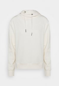 Krämsfärgad hoodie gjord av mjukt material. Har snörning i halsen, elastiska muddarna och en avslappnad passform. Diskret varumärke på bröstet.