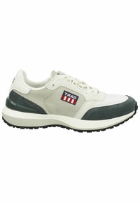 White and gray athletic sneaker with suede accents, textured fabric, a cushioned sole, and a logo patch featuring red and blue stripes.
