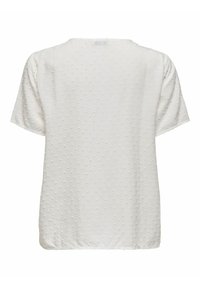 Vit kortärmad topp med texturerat prickmönster, rund halsringning och rak passform. Mjuk tyg med en slät yta.