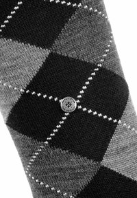 Czarno-szare skarpetki w wzór argyle, wykonane z dzianiny, z okrągłą przypinką z logo Burlington na środku.