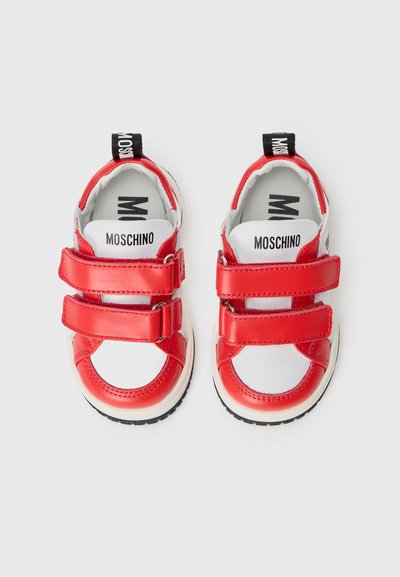 Červené syntetické topánky s dvoma suchými zipsami, bielou medzipodrážkou a čiernou gumovou podrážkou; značené stielky s textom "Moschino".