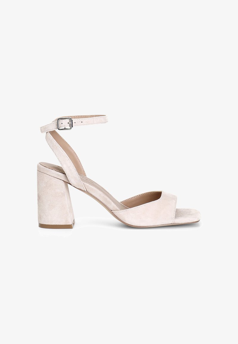Beige mockaim sandal med öppen tå, ankelrem och kraftig blockklack. Slät textur och minimalistisk design med justerbart spänne.