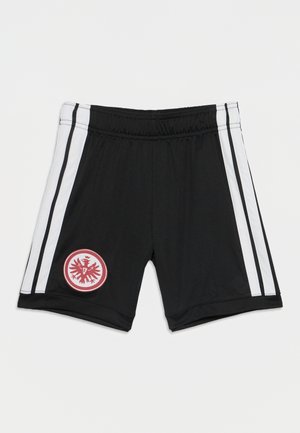 Sorte sportsshorts med hvide sidelommer og et rødt rundt emblem med en stiliseret ørn på venstre ben.