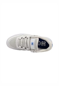 White sneaker with mesh and leather materials, low-top design, padded collar, laces, and blue logo on the tongue. Rubber sole.