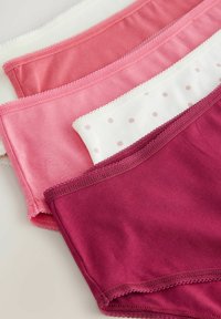 Vijf paar katoenen slipjes in schakeringen van roze, wit met roze stippen, met kantafwerking langs de taillebanden.