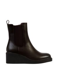 Bottes cheville en cuir marron avec des panneaux latéraux élastiques, un design élégant et une semelle compensée. Dotées d'une boucle pour un enfilage facile.