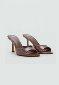 Sandalias de tacón alto de charol marrón, tipo slip-on, con diseño de puntera abierta y tiras anchas sobre el pie. Taco de aguja, textura suave.