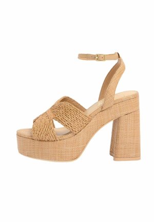 Tan woven platform sandal with chunky high heel, crisscross straps, and ankle buckle closure.