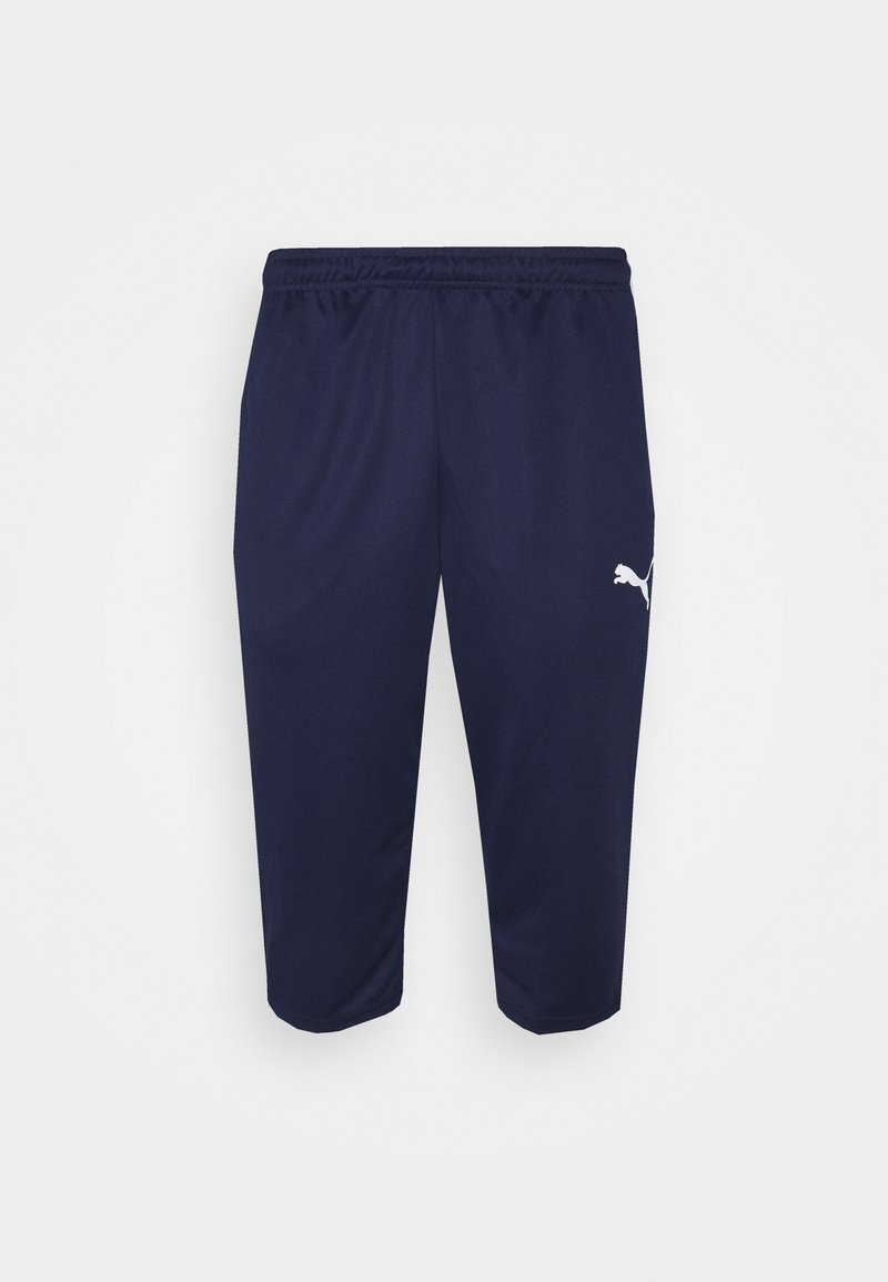 Marineblå træningsbukser med elastisk talje, tapered design og hvid Puma-logo på venstre lår. Blødt, let stof.