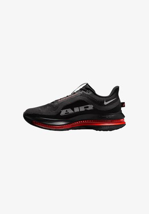 Black athletic shoe with a mesh upper, red accents on the sole, large “AIR” branding, and textured overlays for support and cushioning.