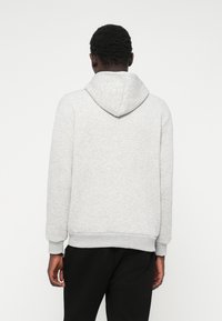 Grey hoodie, cotton blend, features a large hood, long sleeves, ribbed cuffs and hem, and a smooth texture. Curved back design.