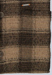 Wool coat featuring a brown and black plaid pattern, textured fabric, two brown buttons, and a small logo tag on the upper side.