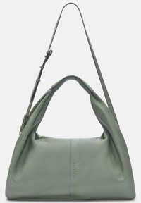 Zielona skórzana torebka o luźnym designie, z podwójnymi uchwytami i regulowanym paskiem. Posiada gładką teksturę i minimalne detale.