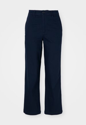 Navyblauwe wijde broek van katoen met een knoopsluiting, voorzakken en subtiele stikseldetails. Op maat gemaakte snit voor comfort.