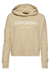 Beige zkrácená mikina s kapucí vyrobená z jemného materiálu, velká přední kapsa, výrazné bílé logo "SUPERDRY" a žebrované manžety.