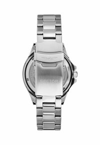 Orologio in acciaio inox argentato con bracciale a maglie, chiusura in metallo solido, cassa rotonda e un fondo trasparente che mostra il movimento.
