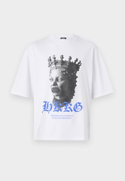 White cotton t-shirt featuring a black-and-white statue print of a crowned figure. Blue text below reads "HKG KINGDOM OF CONCRETE BUILD ON EMOTIONS."