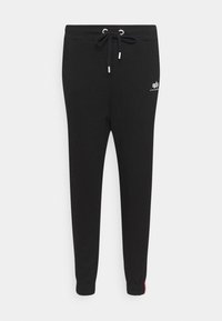 Sorte joggingbukser med snøre i taljen, tapered ben-design, ribbede manchetter og hvidt logo på låret. Blød stofstruktur.