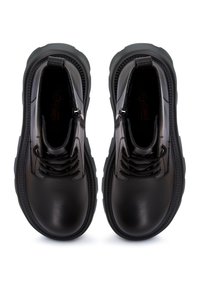Paire de bottines en cuir noir avec semelles épaisses, bouts ronds, fermetures éclair latérales et lacets à l'avant, vues de dessus.