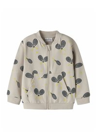 Hellbeige Reißverschlussjacke mit Tennis-Schläger- und Ballmuster in Schwarz und Gelb. Verfügt über gerippte Ärmelbündchen und Taschen, hergestellt aus weichem Material.