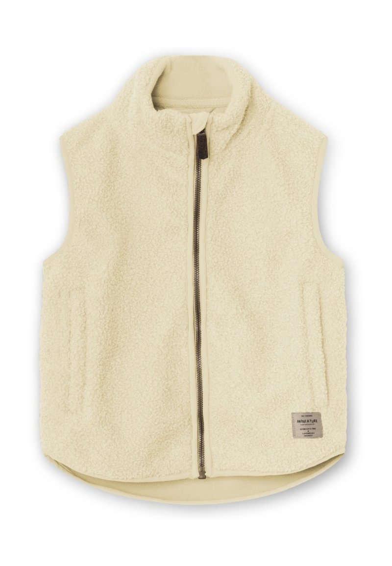 Cremfarbener Fleece-Weste mit hohem Kragen, Reißverschluss und zwei Seitentaschen. Sie verfügt über eine strukturierte Oberfläche und ein Etikett in der unteren rechten Ecke.