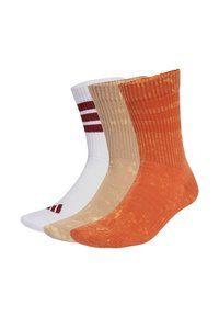 Tri páry ponožiek: biele s červenými pruhmi, béžové a oranžové s textúrovaným vzorom, všetky s rebrovanými manžetami a jednobarevné.