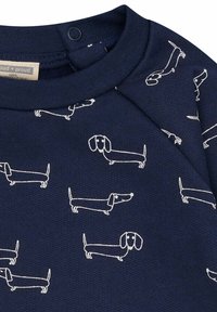 K navyblauer Baumwoll-Sweatshirt mit weißen Dackel-Illustrationen, strukturiertem Stoff, runder Ausschnitt und Druckknopfverschluss an der Schulter.