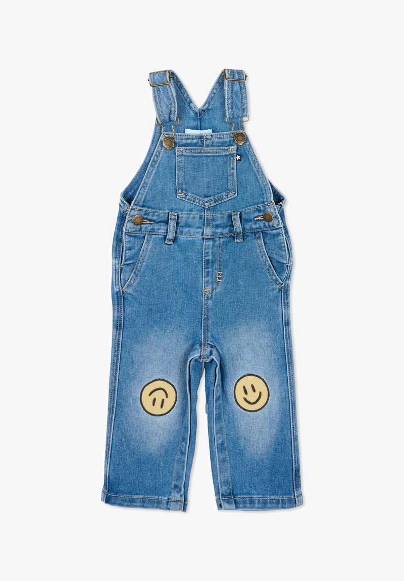 Salopette en denim bleu pour enfants avec bretelles ajustables, poche frontale et deux écussons jaunes souriants sur les genoux.