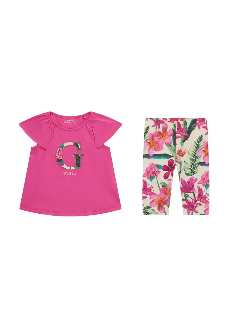 Top rosa a maniche corte con design floreale "G", abbinato a leggings off-white con vivace motivo floreale in rosa e verde.
