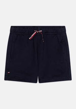 Navy blue cotton shorts with elastic waistband and adjustable red, white, and blue drawstring. Features two side pockets.