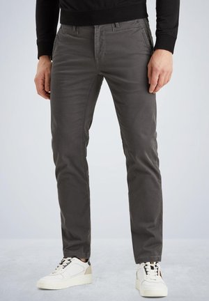 Gray slim-fit pants made from cotton blend fabric, featuring a smooth texture, front pockets, and subtle stitching details. Paired with white sneakers.