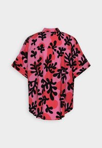 Camicia a maniche corte con sfondo rosa e grandi motivi astratti neri e rossi; vestibilità ampia con orlo dritto e dettagli nella yoke posteriore.