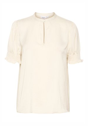 Blouse couleur crème avec un col mandarin, une ouverture en forme de clé à l'avant et des manches bouffantes froncées. Fabriquée en tissu léger et doux.