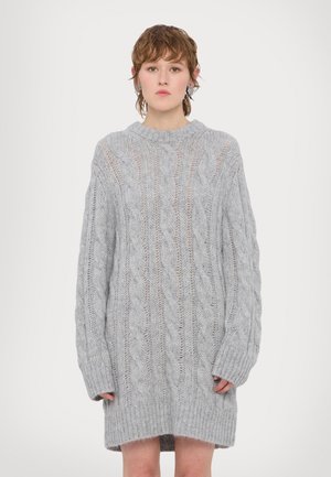 Harmaa puikkomuhvi oversized villatakki mekko, jossa on pitkät hihat, ribbausvarsit ja teksturoitu kuvio koko matkalta. Pehmeä, löysä istuvuus.