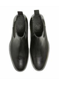 Chaussures en cuir noir à enfiler avec des panneaux élastiques sur les côtés, design à bout pointu et détails de couture subtils. La doublure interne présente un logo de marque.